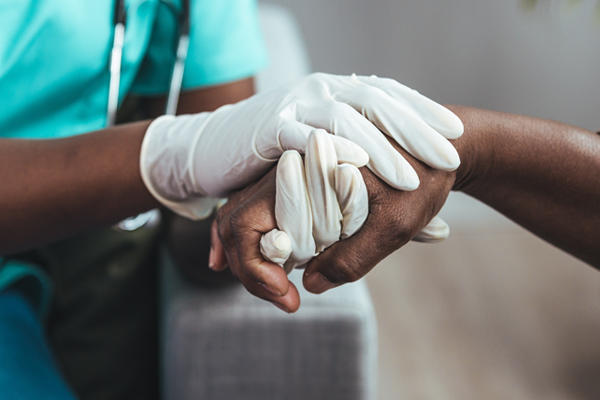 medical pro holding patient's hand