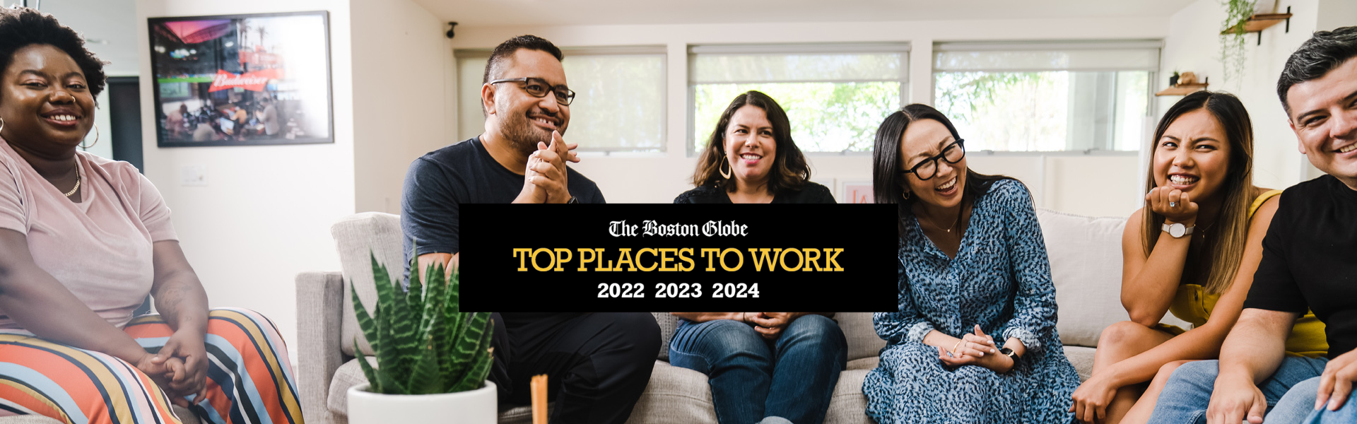 Group of staff members with logo for The Boston Globe's Top Places to Work 2022, 2023, and 2024 – Massachusetts
